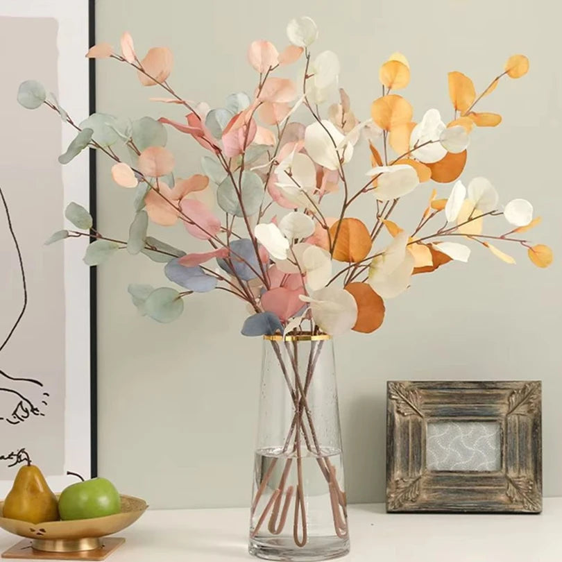 bouquet artificiel feuilles ovales rose pâle moderne vase transparent décoration intérieure minimaliste naturelle exposition