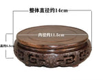 support circulaire bois sculpté artisanal traditionnel marron foncé détails complexes vase plantes décoration maison