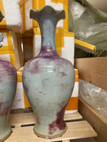Vase décoratif en céramique émaillée de couleurs turquoise et violet foncé, avec un design irrégulier et texturé.