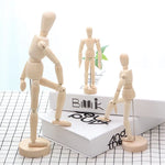 mannequins articulés bois classiques tailles diverses naturel clair base circulaire minimalistes adultes