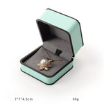 boîtes bijoux cuir beige turquoise intérieur noir moderne emballage présentation anneaux haute qualité
