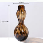 vases modernes translucides opaques motifs tourbillonnaires branches fleurs artificielles marron orange beige