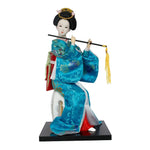 poupée japonaise geisha argile broderie florale motifs géométriques accessoires traditionnels blanc rouge vert bleu