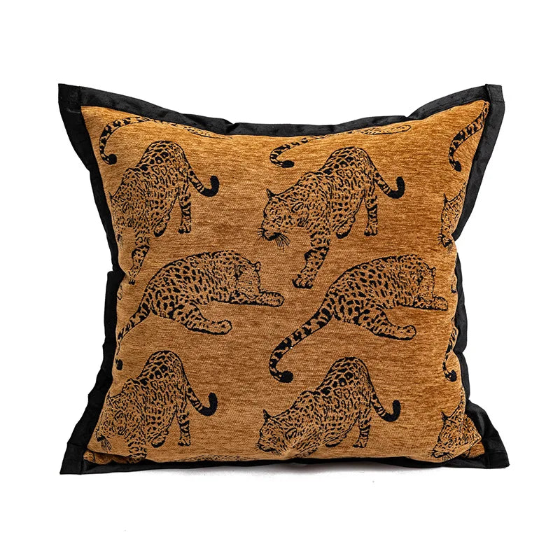 Coussin décoratif avec impression de léopards sur un fond doré.