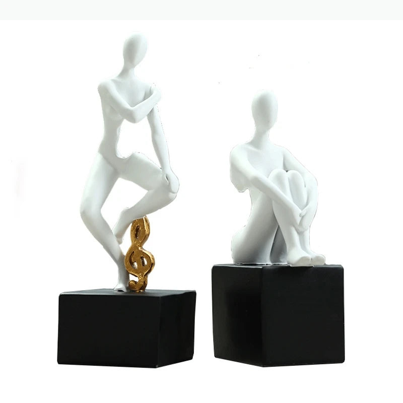 statues décoratives minimalistes figures humaines stylisées blanc noir élément doré moderne abstrait