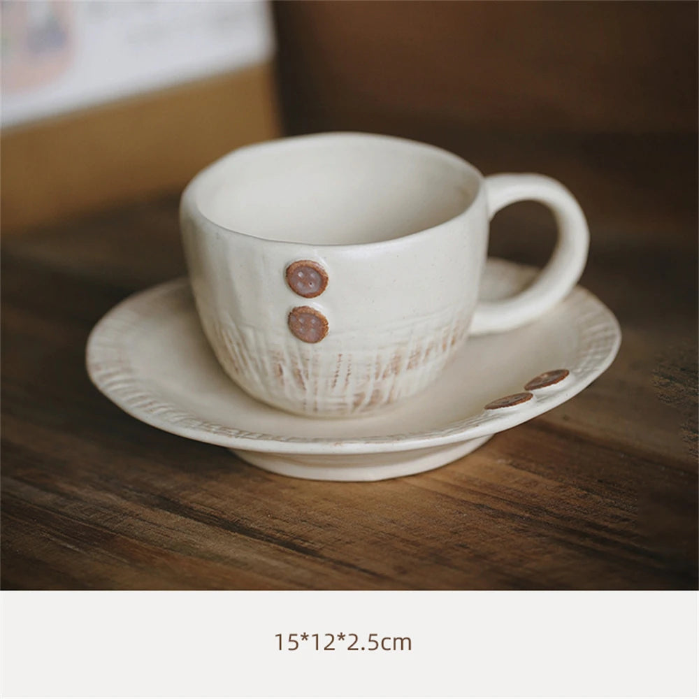 Une tasse et une soucoupe élégantes en céramique blanche, ornées de petits boutons décoratifs.