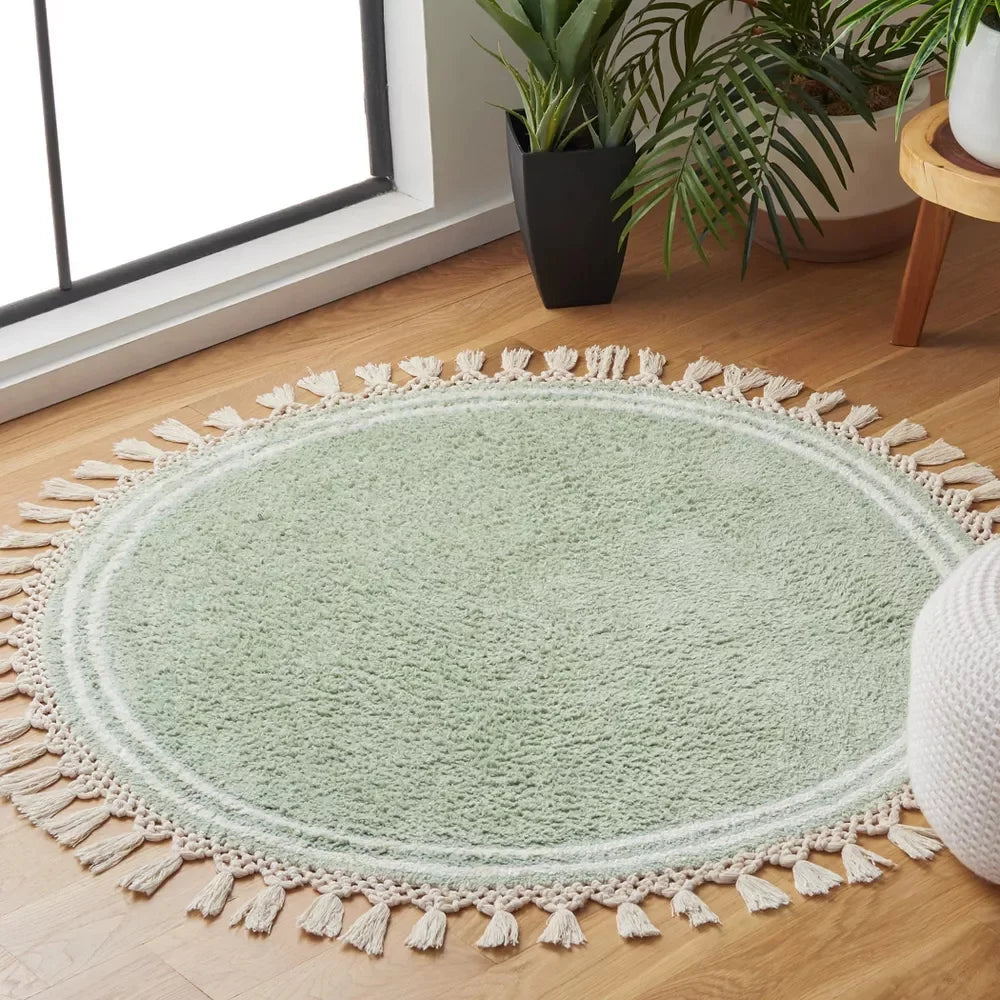 tapis rond moderne vert clair texture douce franges blanches salon chambre bébé