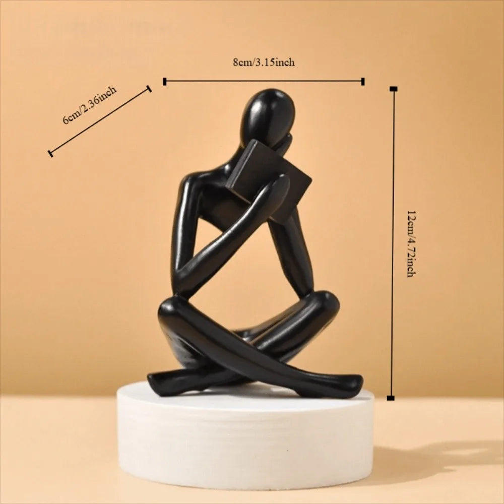 figurine deco moderne or noir blanc personne assise livre socle chambre abstraction minimalisme