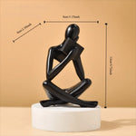 figurine deco moderne or noir blanc personne assise livre socle chambre abstraction minimalisme