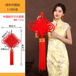 guirlande traditionnelle chinoise tissée artisanale rouge motifs géométriques pompon ruban doré festive printemps