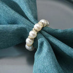 anneau serviette strass dorés classique élégant blanc or événements table luxueux fixations