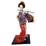 poupée japonaise geisha argile broderie florale motifs géométriques accessoires traditionnels blanc rouge vert bleu