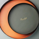 présentoir rond moderne plateau uni vert foncé orange noir maquillage soins parfums cosmétiques table