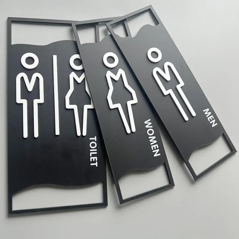 signalisation toilettes moderne symboles homme femme texte TOILET bois brun clair blanc tringle noire