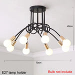 suspension lumineuse moderne noir doré ampoules blanches structure spirale fixation câbles métallique