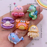 bijoux résine marine créatures poissons crabes pieuvres blanches rose verte