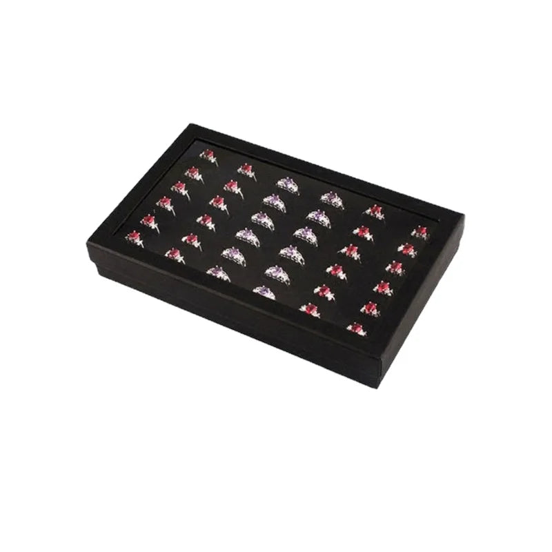 présentoir bijoux moderne boîte transparente 21.5cm 13.7cm 3.2cm alvéoles rectangulaires plusieurs bagues noires argentées