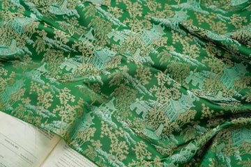 tissu brocart vert foncé motifs asiatiques semi transparent traditionnel décoration artisanale fleurs livre
