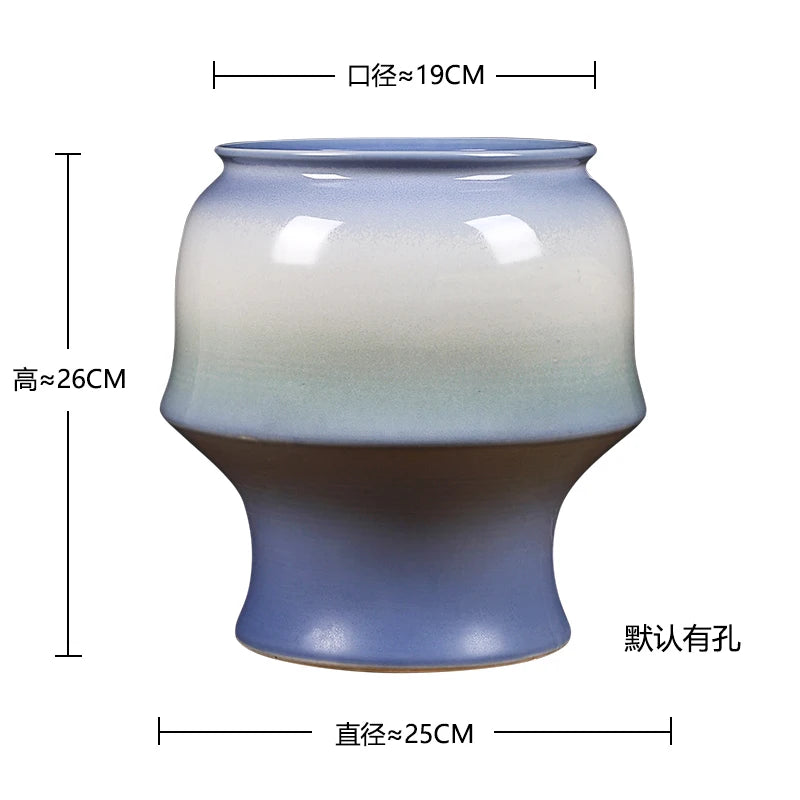 Pot en céramique de forme ronde avec un dégradé de couleurs allant du bleu ciel au marron foncé, mesurant environ 25 cm de diamètre et 26 cm de haut.
