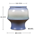 Pot en céramique de forme ronde avec un dégradé de couleurs allant du bleu ciel au marron foncé, mesurant environ 25 cm de diamètre et 26 cm de haut.