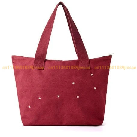 sac main rouge bordeaux étoiles blanches poche zippée poignées détachables moderne casual