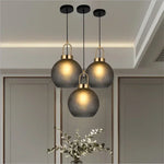 suspension lumineuse moderne gris fumé doré verre mat métal poli ampoule filament visible chambre