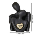 statuette couple stylisé blanc noir cœur doré moderne minimaliste or texturée aspect granuleux