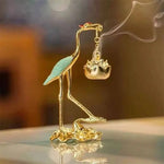 statuette oiseau or noir bleu artisanal élégant décoration maison motif floral support métal