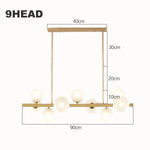 suspension lumineuse moderne or blanc boules translucides chaines interrupteur tactile