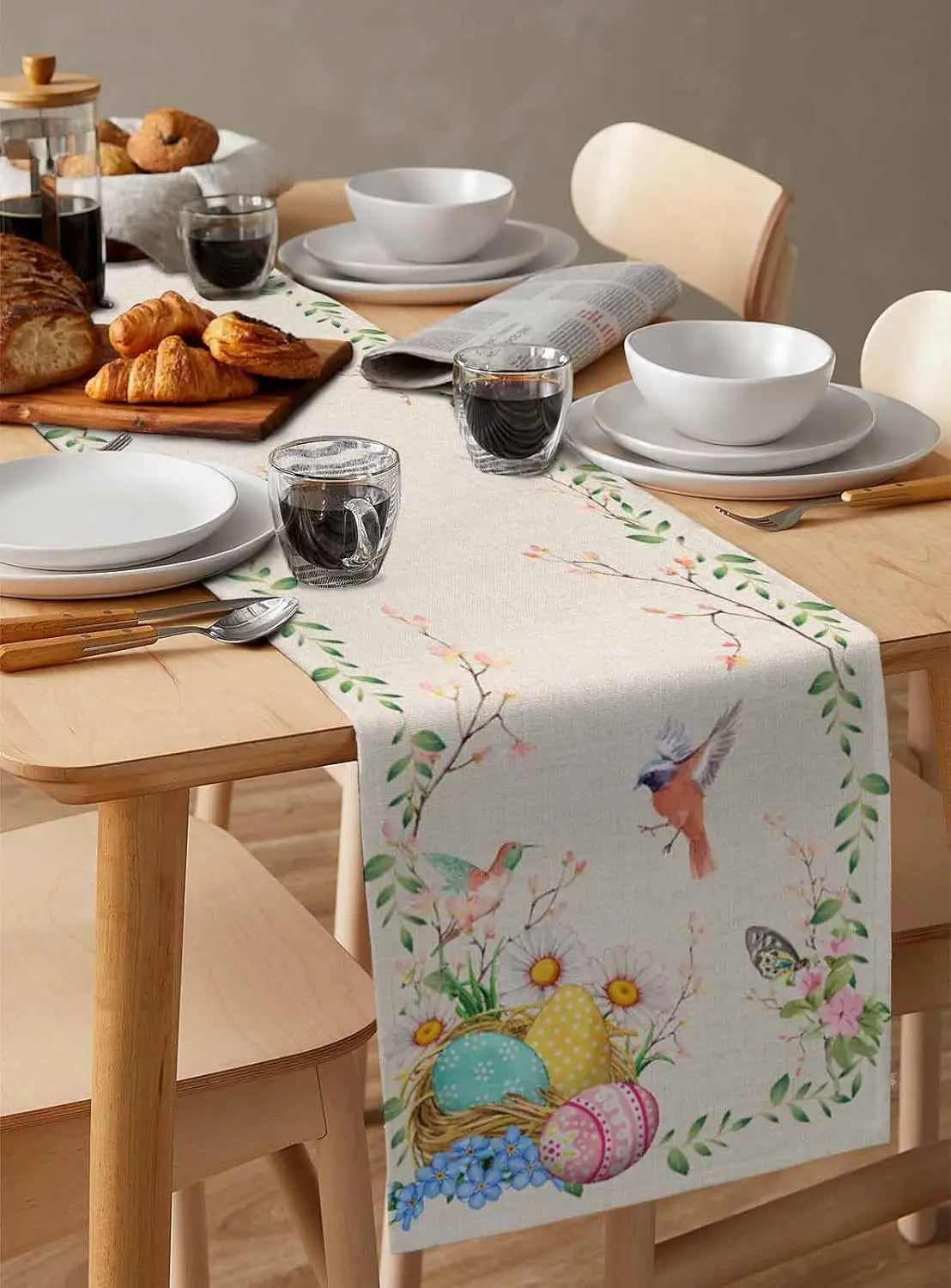 Un magnifique chemin de table aux motifs printaniers accueillant une table joliment dressée pour un repas convivial.
