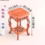 table basse bois rose classique gravures artisanal marron clair pot plante figurine cadre photo