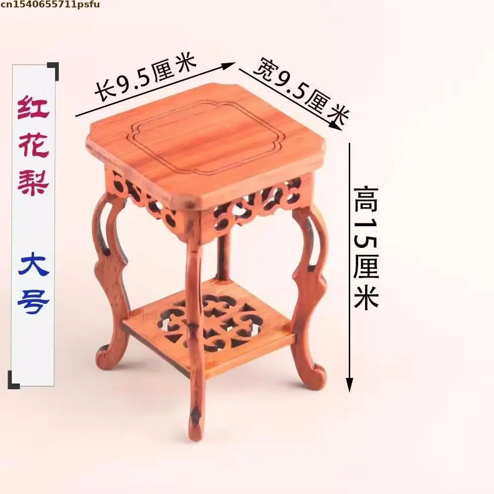 table basse bois rose classique gravures artisanal marron clair pot plante figurine cadre photo