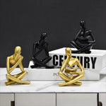 figurine deco moderne or noir blanc personne assise livre socle chambre abstraction minimalisme