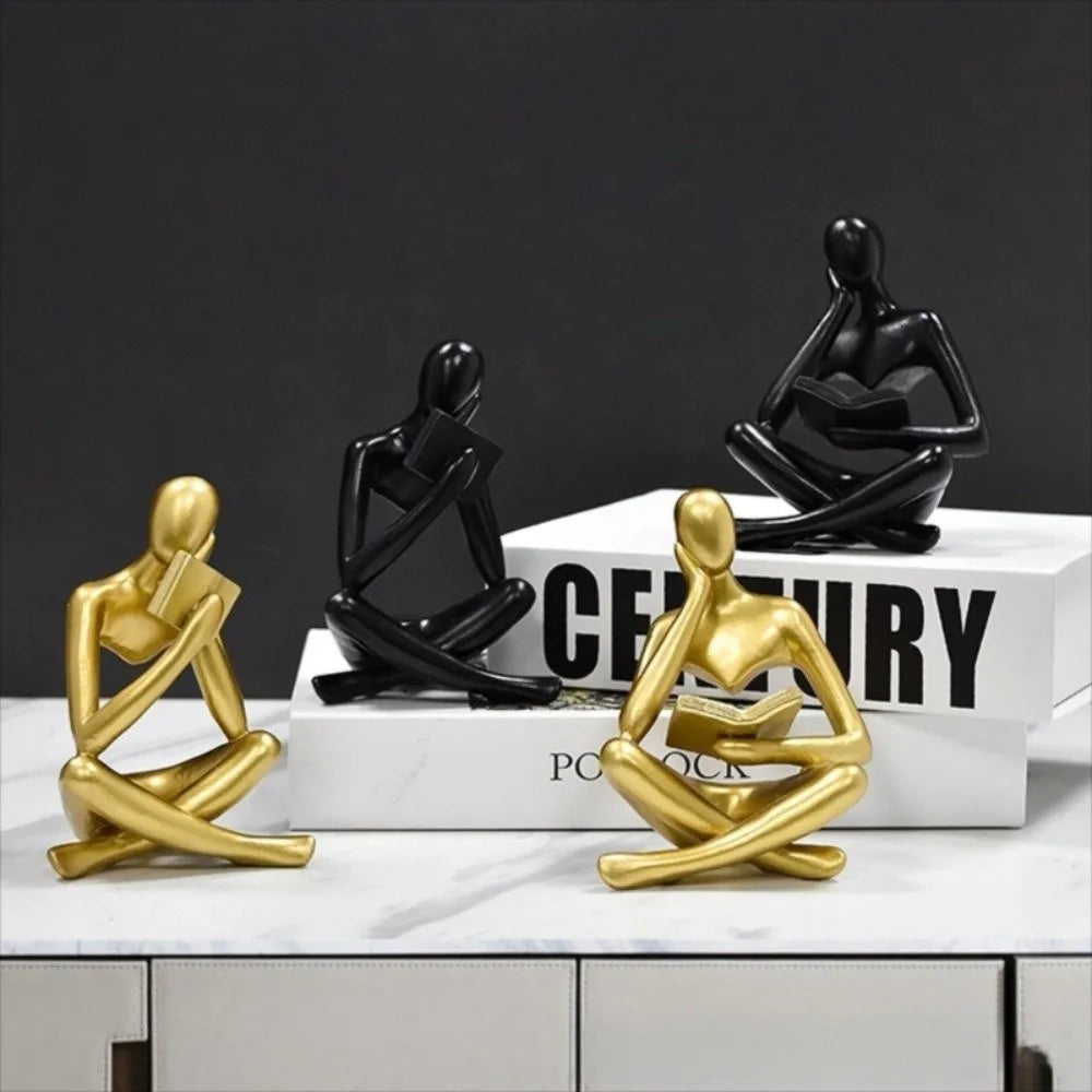 figurine deco moderne or noir blanc personne assise livre socle chambre abstraction minimalisme