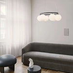 suspension lumineuse moderne câbles suspendus sphères translucides dorées blanches salon restaurant
