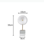 décoration moderne lampes sculpturales transparentes abatjours texturés base cube doré blanc chambre