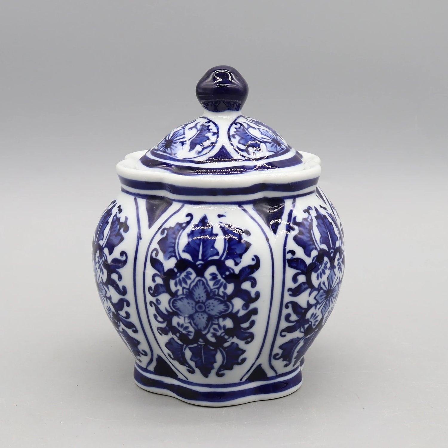 Pot de stockage en porcelaine bleue et blanche orné de fleurs et de motifs floraux complexes.