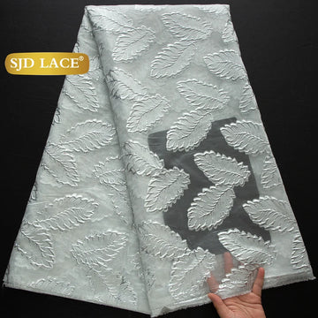 tissu dentelle polyester nylon largeur 51 pouces motifs feuilles stylisées couleurs noir vert rose