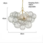 suspension lumineuse moderne verre transparent chaîne dorée led acier poli contemporain lumière chaude chambre