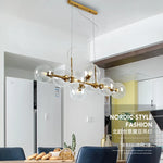 Suspension lumineuse moderne sphères transparentes dorées structure métallique noir chambre salon