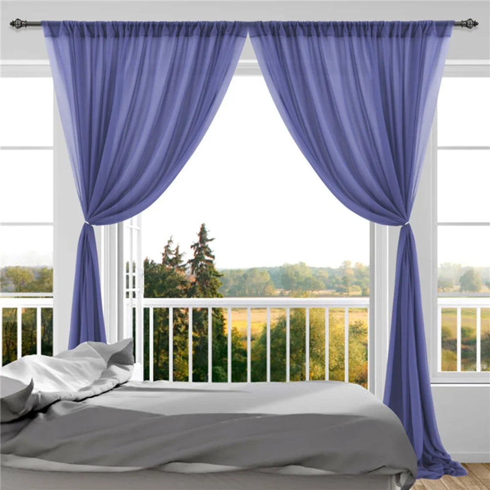 Une chambre lumineuse avec des rideaux violets et une vue imprenable sur un paysage forestier aux couleurs automnales.