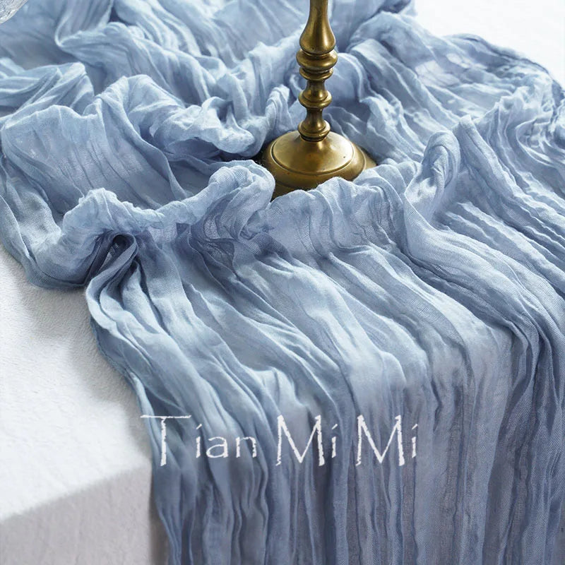 Une robe bleu pâle aux plis élégants, flottant gracieusement autour d'un support doré, créant une scène captivante et raffinée.