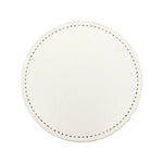 Miroir rond blanc avec de petits points noirs en bordure.