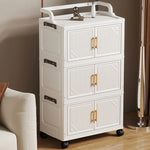 meuble rangement pliable blanc roulettes portes poignées dorées vêtements