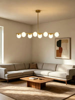 Suspension lumineuse moderne or blanc sphères blanches structure dorée salon chambre