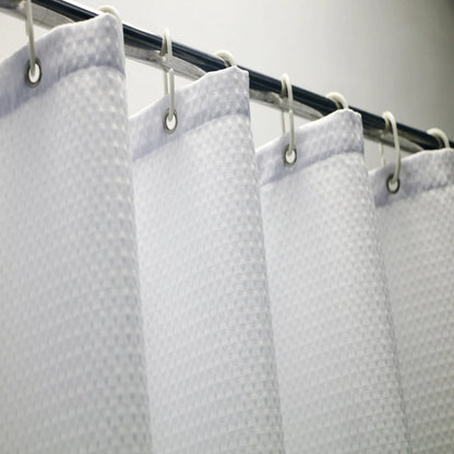 Rideau de douche blanc, accessoire de salle de bain et élément de plomberie, apportant une touche moderne et élégante à l'intérieur de la salle de bain grâce à son design élégant et sa finition métallique.