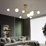luminaire suspension moderne sphères translucides structure métallique dorée éclairage salon salle manger chambre