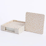 Plateau de service en carton beige avec motifs dorés en forme de vagues, comprenant 6 sous-verres assortis.