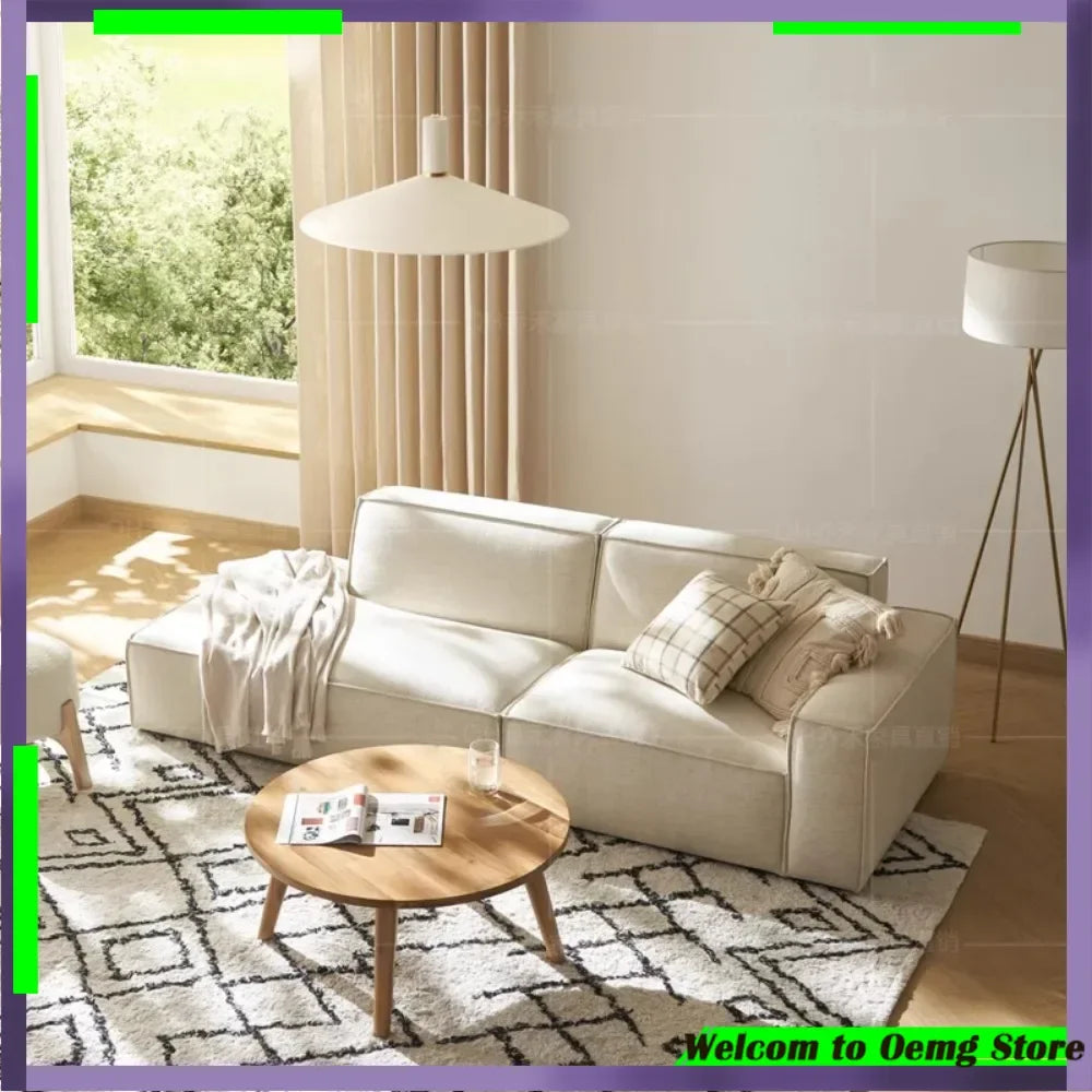 canapé d'angle moderne beige clair uni confortable salon minimaliste inclusion coussins tapis