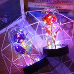 lampe led rose stabilisée dorée feuilles vertes moderne nuit multicolore base noire verre transparent
